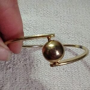 Goldtone asymmetrical ball bangle bracelet